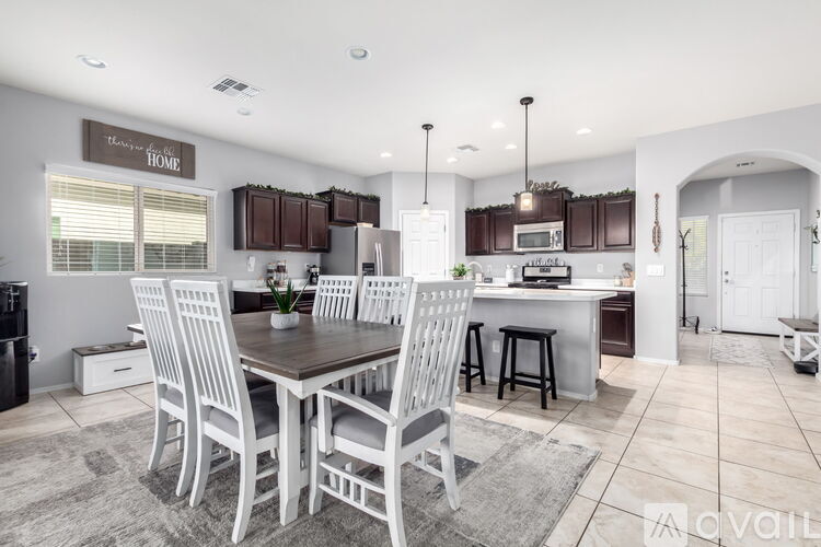 A modern kitchen with a dining table and chairs.