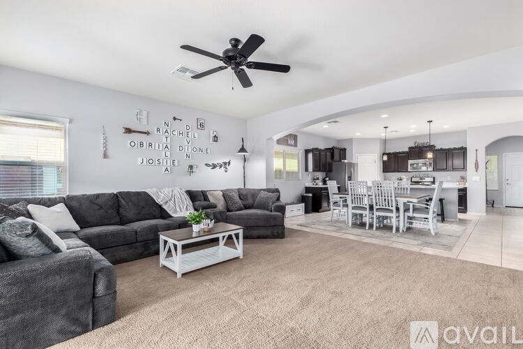 A living room with a grey sofa and a white coffee table.