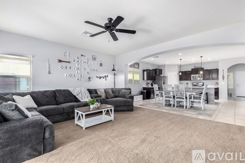 A living room with a grey sofa and a white coffee table.
