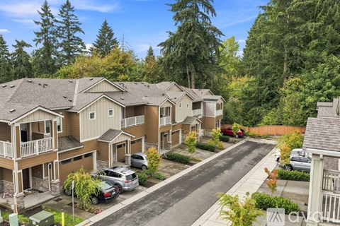 A row of houses with trees in the background.