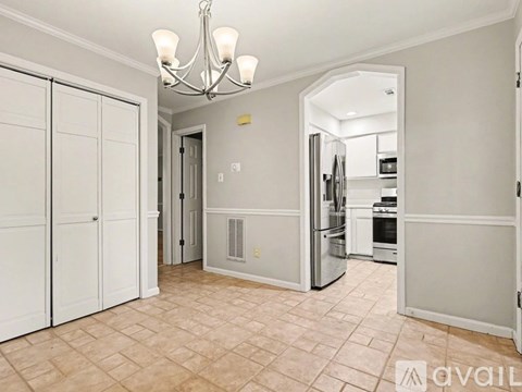 A kitchen with a refrigerator, oven, and microwave.