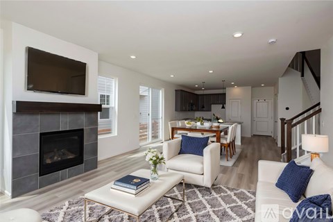 A modern living room with a fireplace and a television.