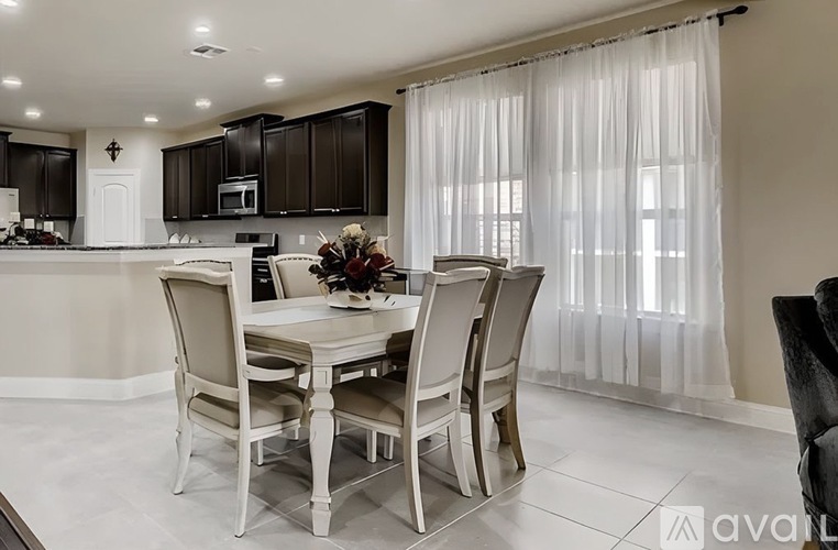 A dining room with a table set for four.