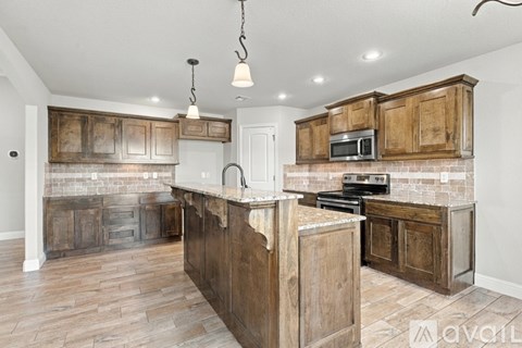 A kitchen with wooden cabinets and a brick backsplash.