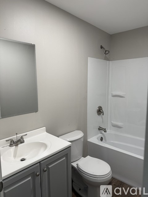 A bathroom with a toilet, sink, and bathtub.