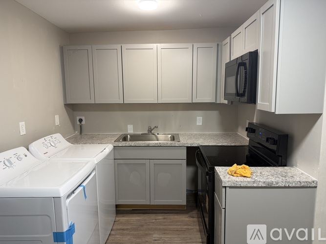 A small kitchen with a washer and dryer.