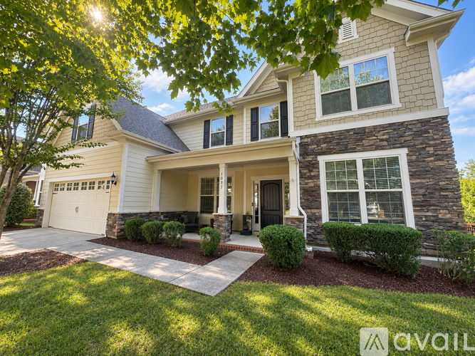 A house with a garage and a driveway is for sale.