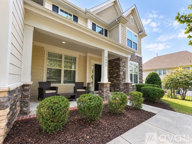 A house with a front yard and landscaping.