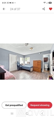 A bedroom with a bed, dresser, and mirror.