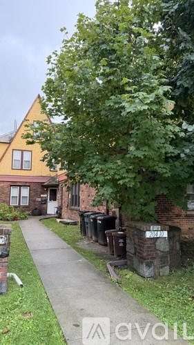 A tree is in front of a house.