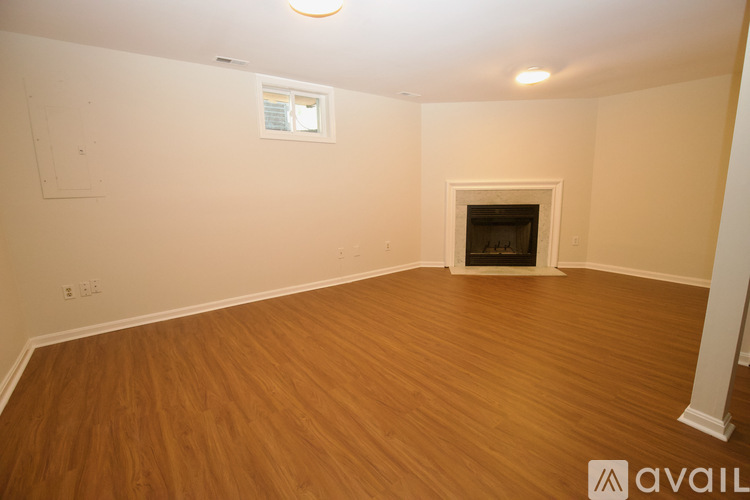 A room with a fireplace and wooden floors.