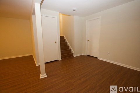 A room with wooden floors and white walls.