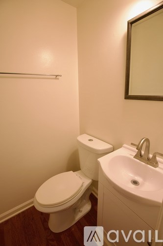 A white toilet and sink in a small bathroom.