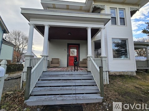 A house with a red door and a porch.