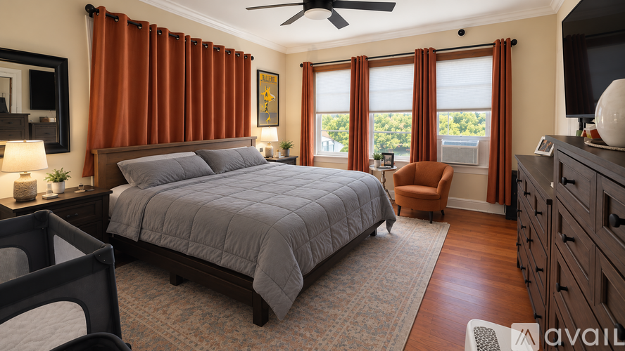 A bedroom with a large bed and a ceiling fan.