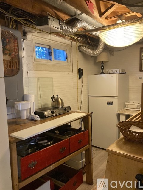 A kitchen with a stove top oven and a refrigerator.