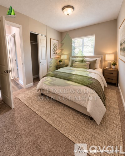 A bedroom with a bed, nightstands, and a rug.