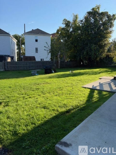 A grassy area with a white building in the background.