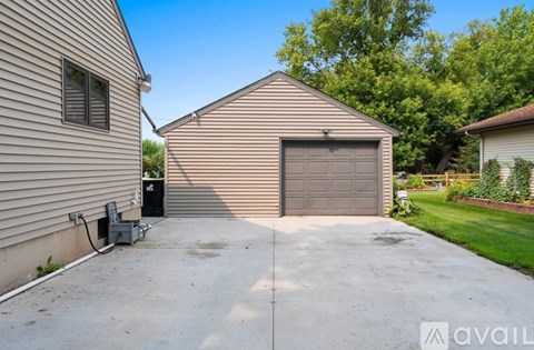 A detached house with a garage is for sale.