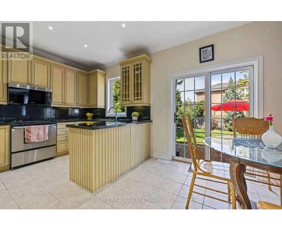 A kitchen with wooden cabinets and a black countertop.
