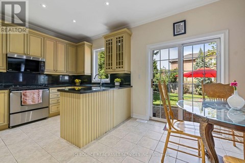 A kitchen with wooden cabinets and a black countertop.