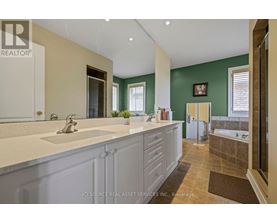 A bathroom with a green wall and a white sink.