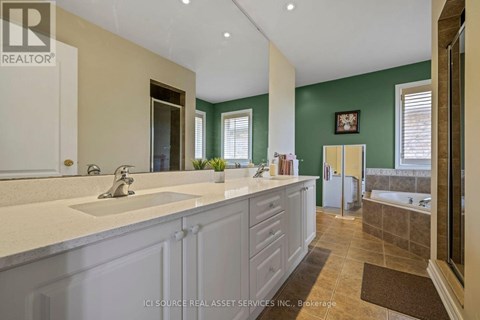 A bathroom with a green wall and a white sink.