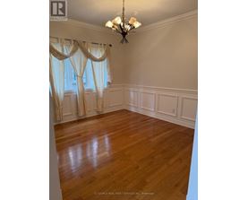 A room with wooden floors and a chandelier.