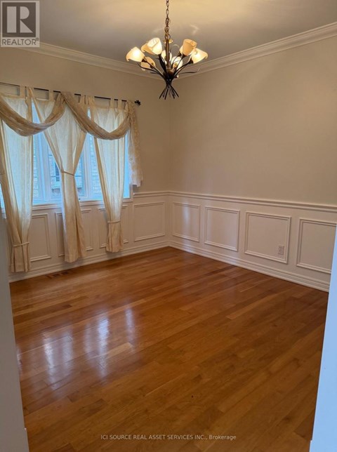 A room with wooden floors and a chandelier.