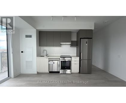 A modern kitchen with stainless steel appliances and white cabinetry.