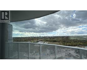 A view from a balcony overlooking a cityscape with a sign that reads "RE/MAX DASH REALTY Brokerage".