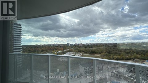 A view from a balcony overlooking a cityscape with a sign that reads "RE/MAX DASH REALTY Brokerage".