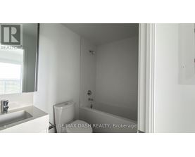 A white bathroom with a toilet, sink and bathtub.