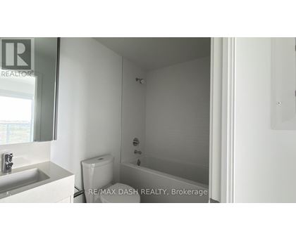 A white bathroom with a toilet, sink and bathtub.