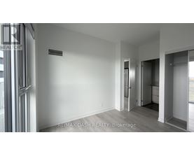 A room with a door and a window with a sign RE/MAX DASH REALTY, Brokerage.
