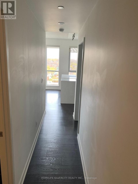 A long hallway with a door at the end.