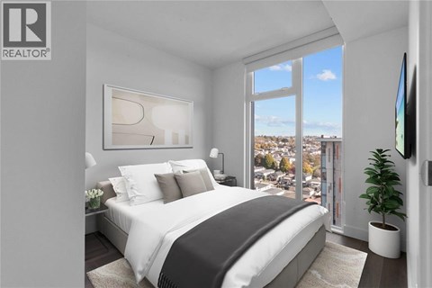 A bedroom with a large bed and a view of the city.