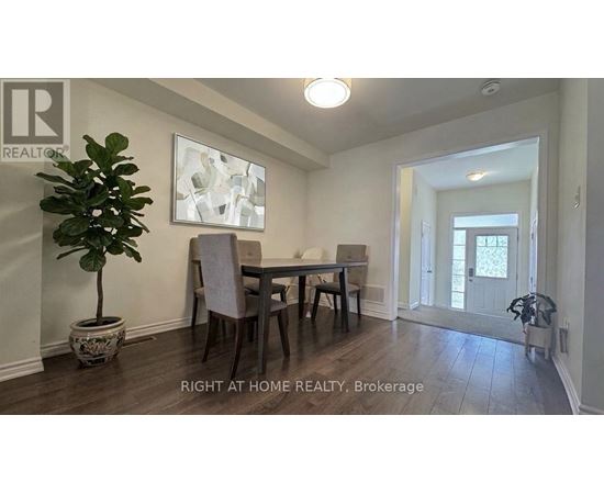 A dining room with a table and chairs.