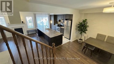 A well-lit kitchen with a dining table and chairs.