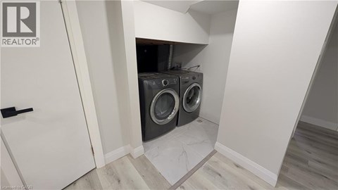 A laundry room with a washer and dryer built into the wall.