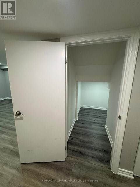 A white door is open to a hallway.