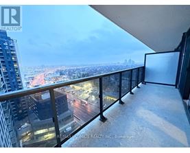 A balcony with a view of a cityscape at night.