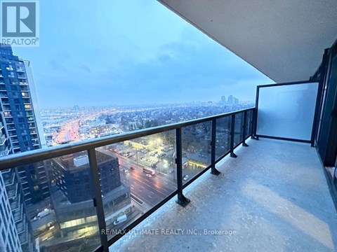 A balcony with a view of a cityscape at night.