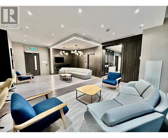 A living room with a grey sofa and blue chairs.