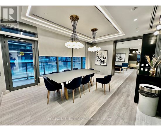 A modern dining room with a long table and chairs.