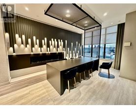 A modern office space with a long table and chairs.