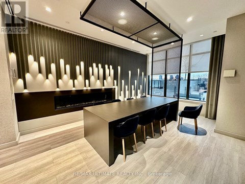 A modern office space with a long table and chairs.