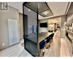 A modern kitchen with a dining table and chairs.