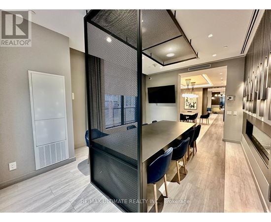 A modern kitchen with a dining table and chairs.
