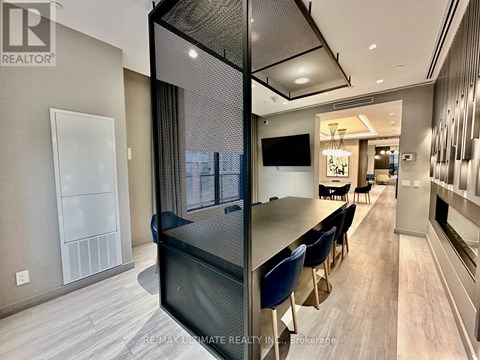 A modern kitchen with a dining table and chairs.